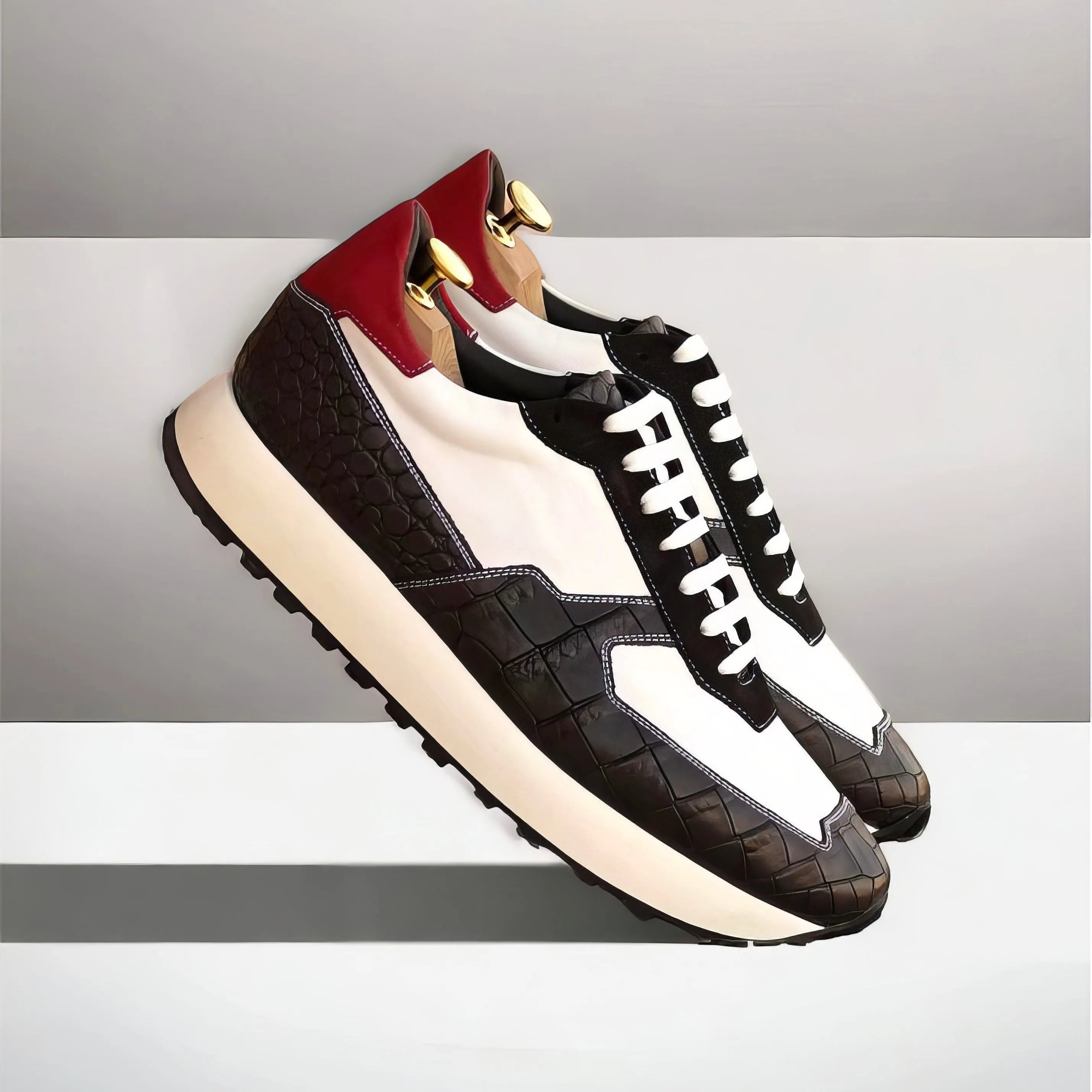 Black and white croc-embossed leather sneakers with red accents on the heel.