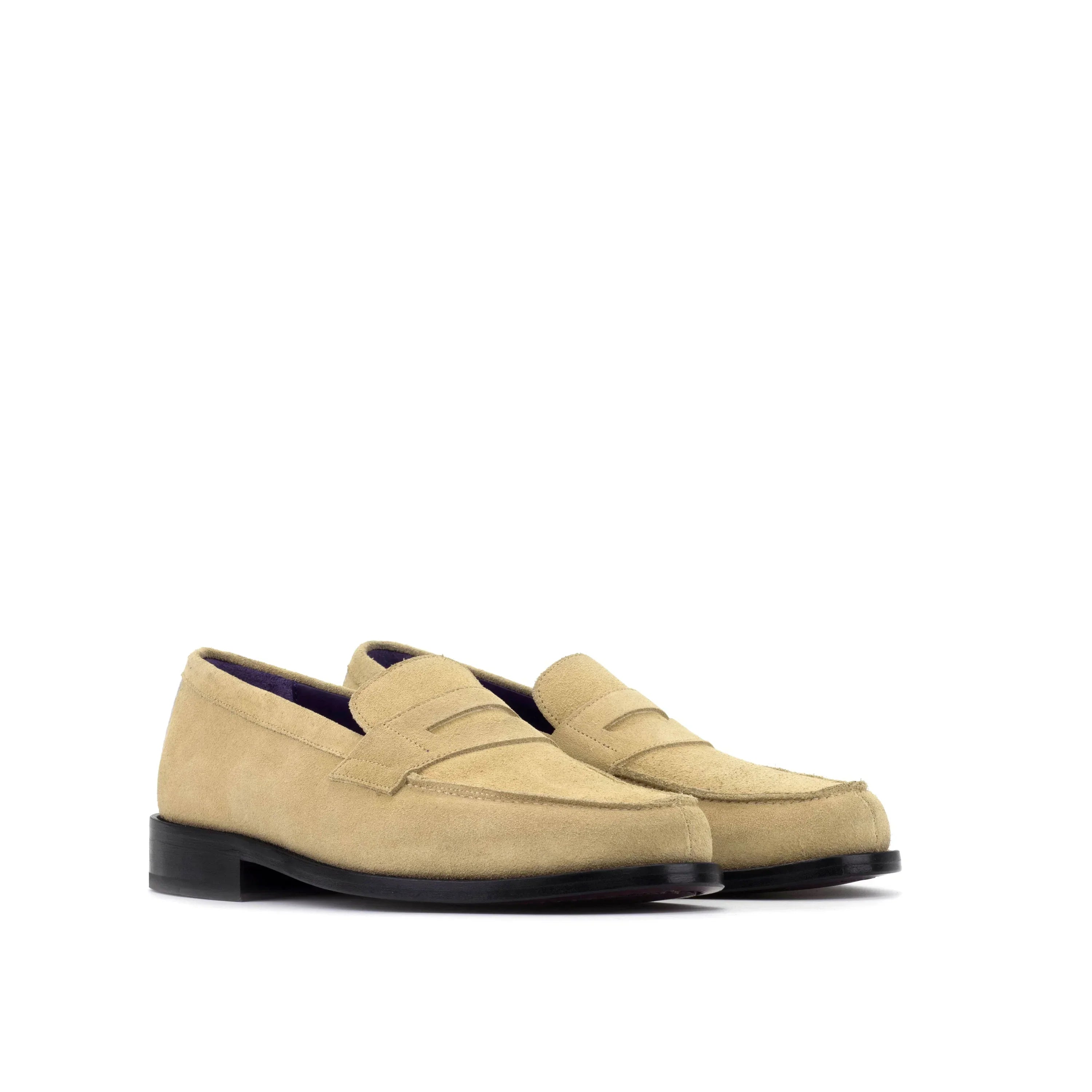 Beige suede loafers with a classic penny loafer design and black rubber soles.