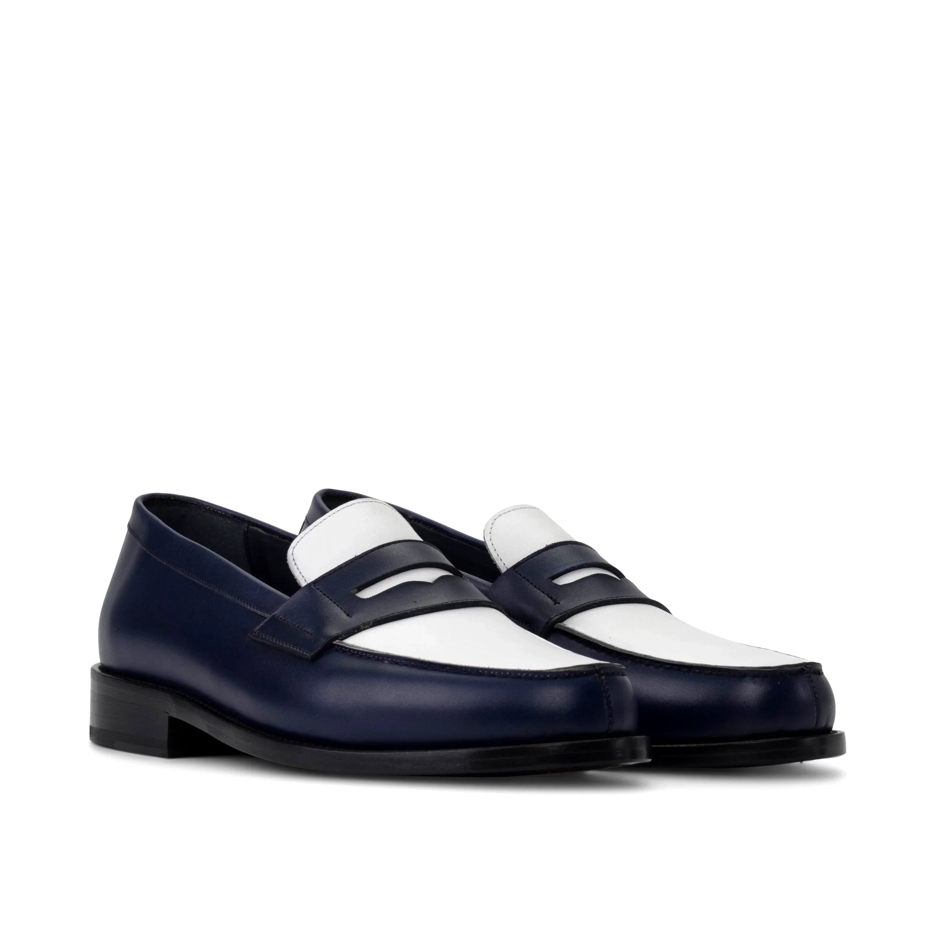 Navy and white two-tone leather loafers with a classic penny loafer design.