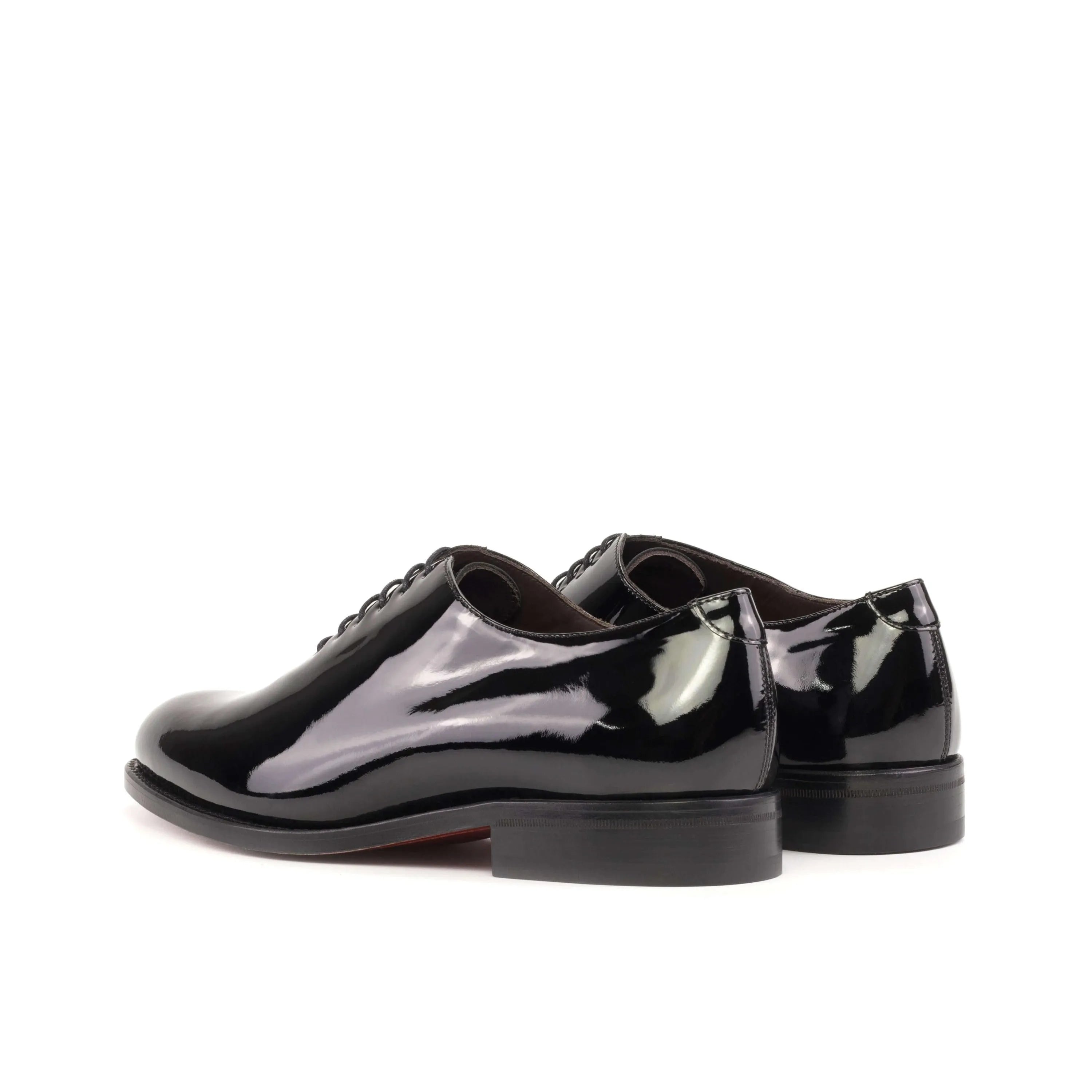 Shiny black Agent Wholecut shoes pair, rear view