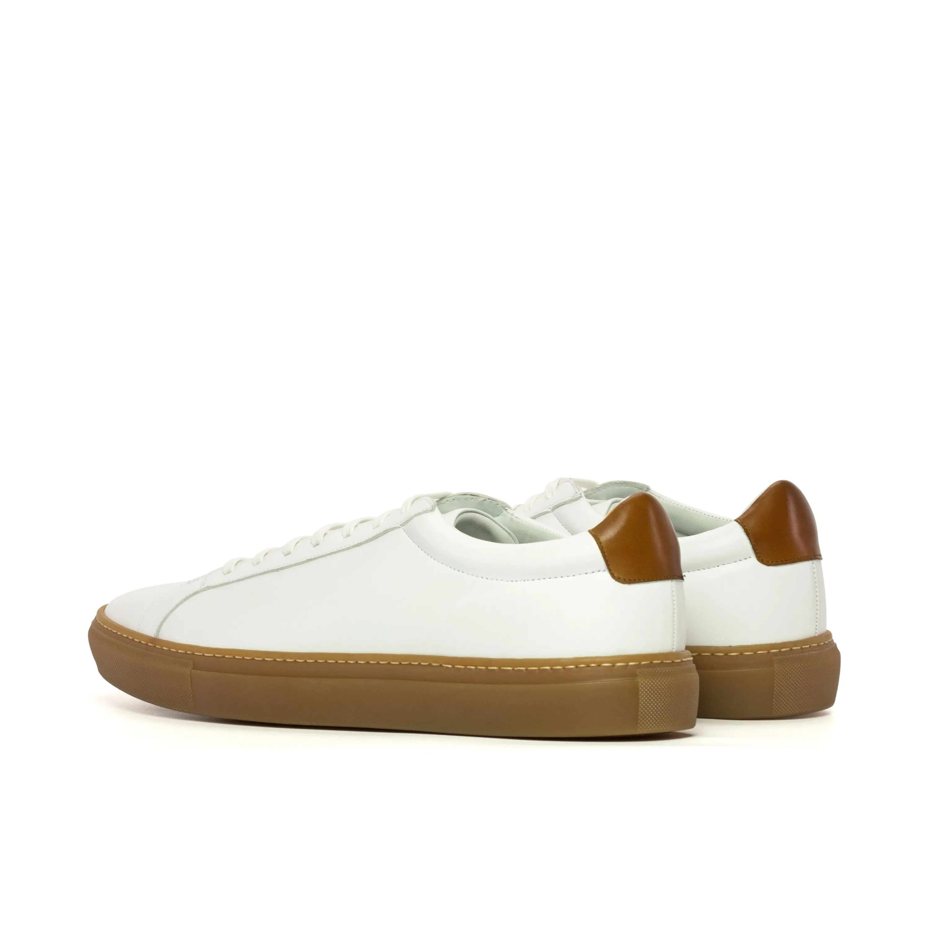 Conquest low kick sneaker with white leather and brown soles