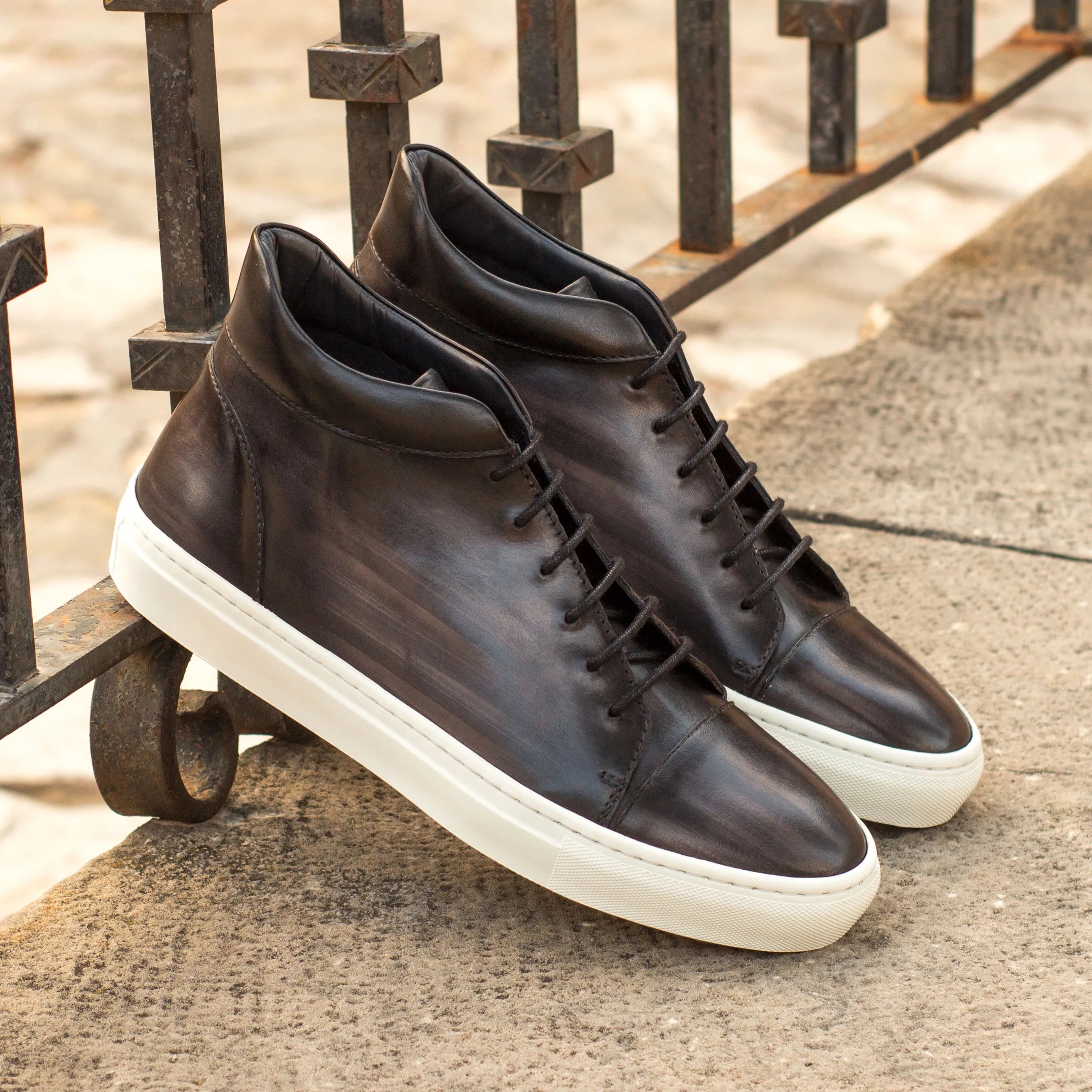 Pair of Donny Patina high top sneakers II in dark leather