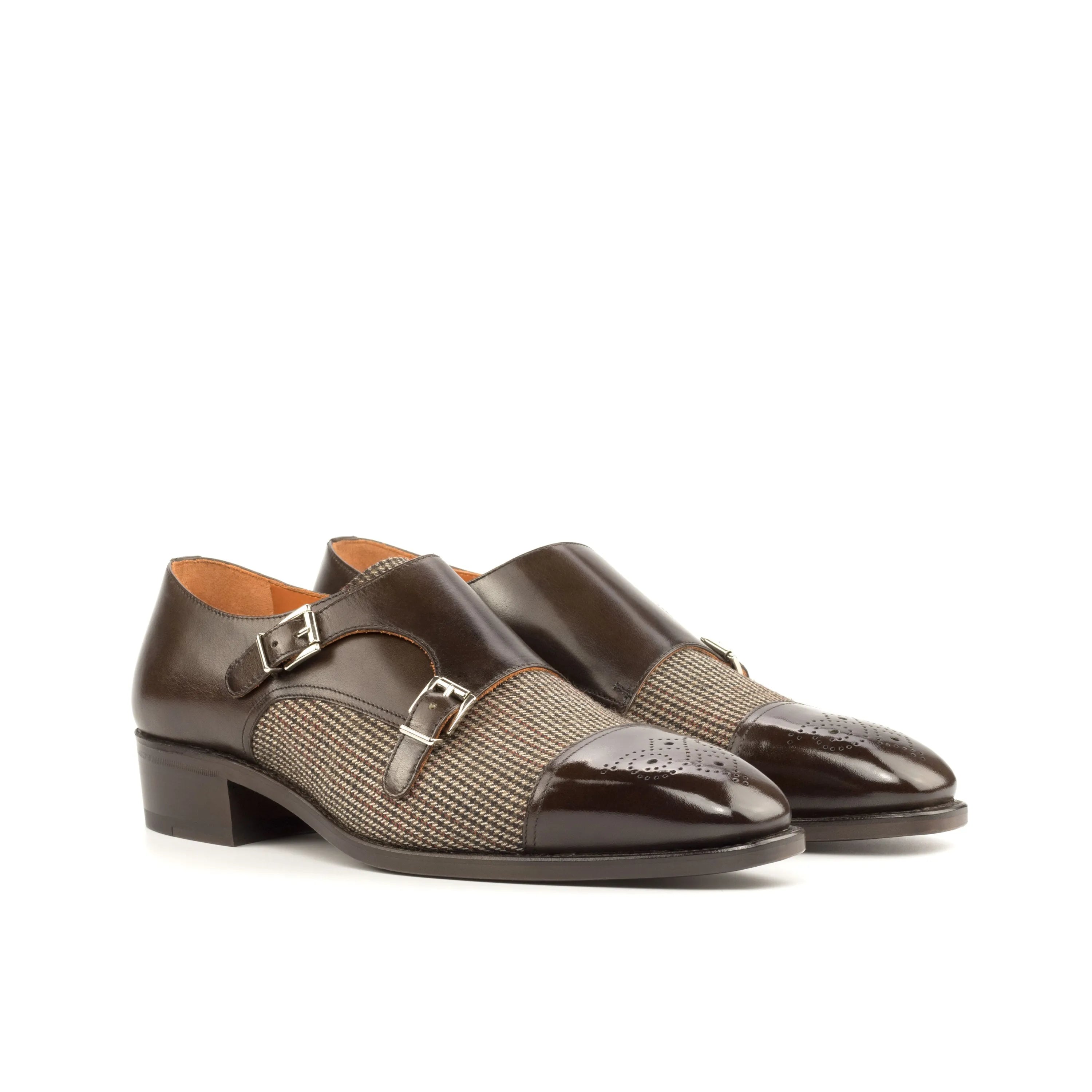 Brown double monk strap shoes with a herringbone-patterned leather panel and polished toe cap.