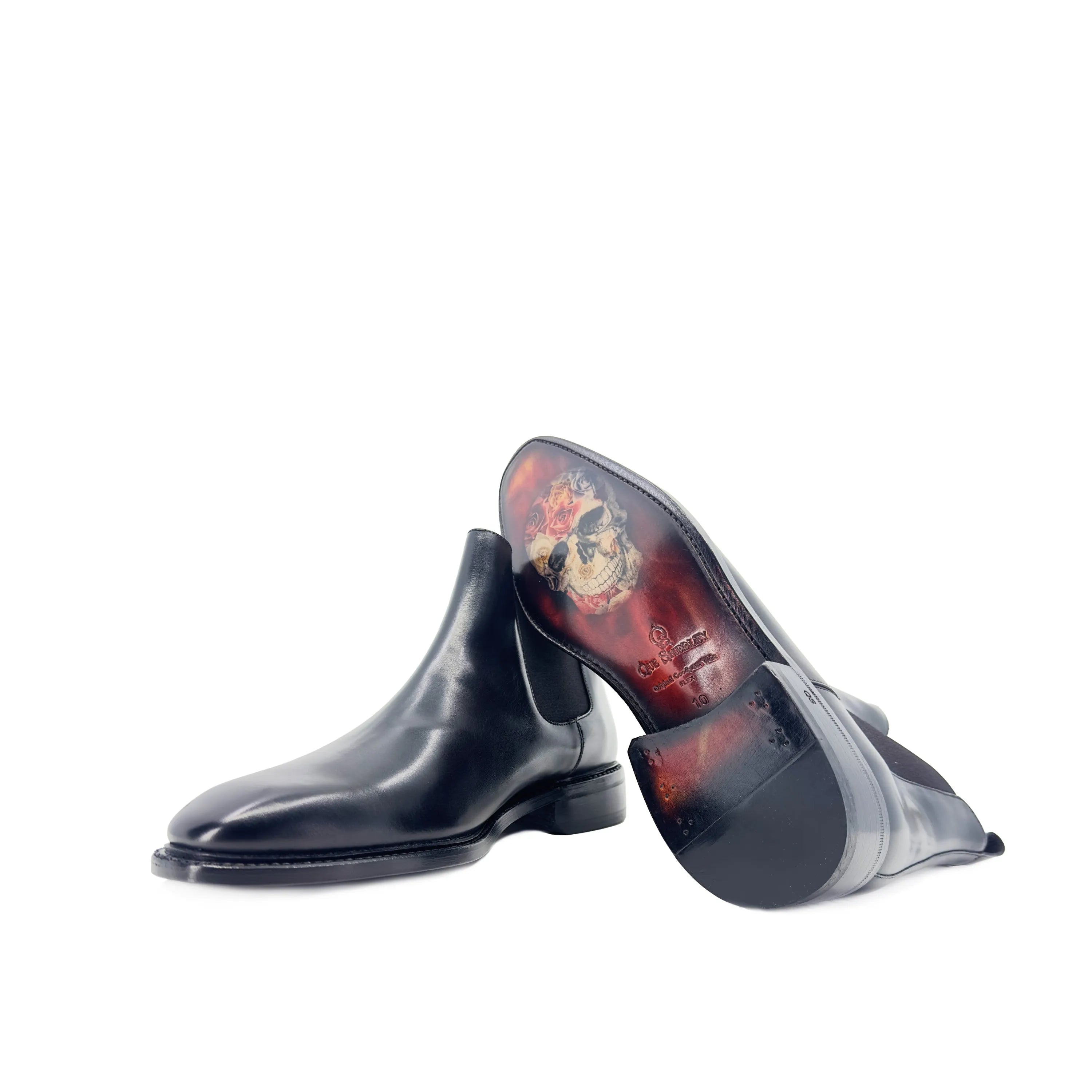 Pair of black leather Cave Chelsea boots with decorative soles