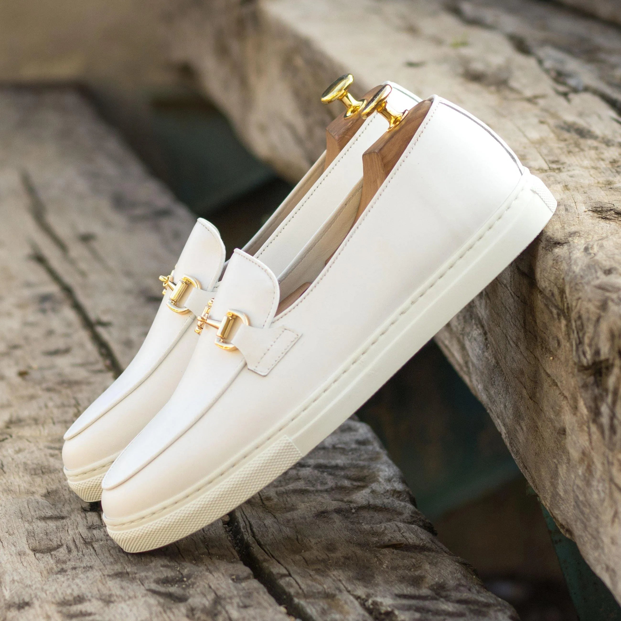Pair of white leather Frais Belgian sneaker loafers with gold hardware