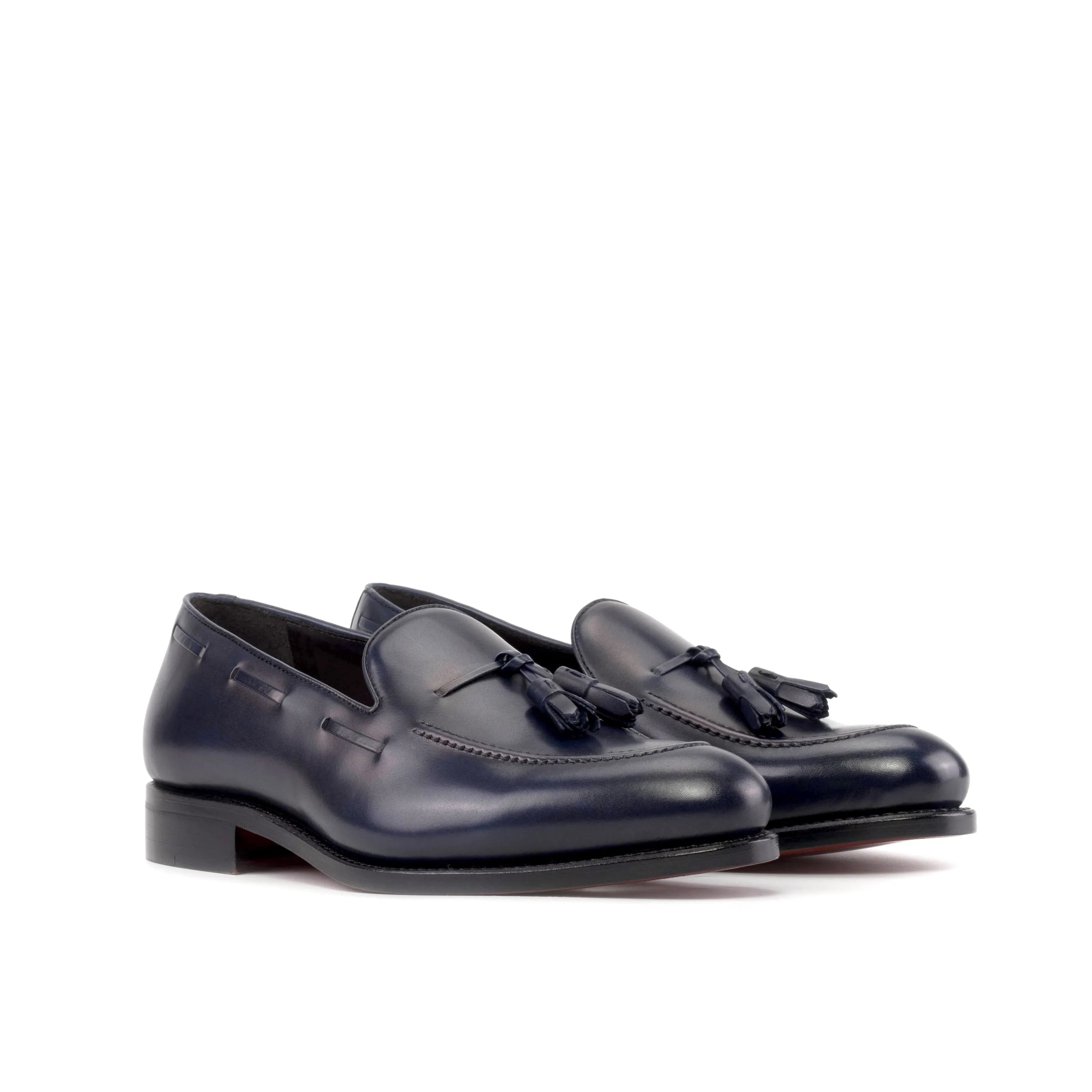 Pair of navy blue leather tassel Sable Loafers, back view. Ships fast lane in 2-3 business days